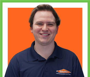 male posing for SERVPRO photo on white wall 